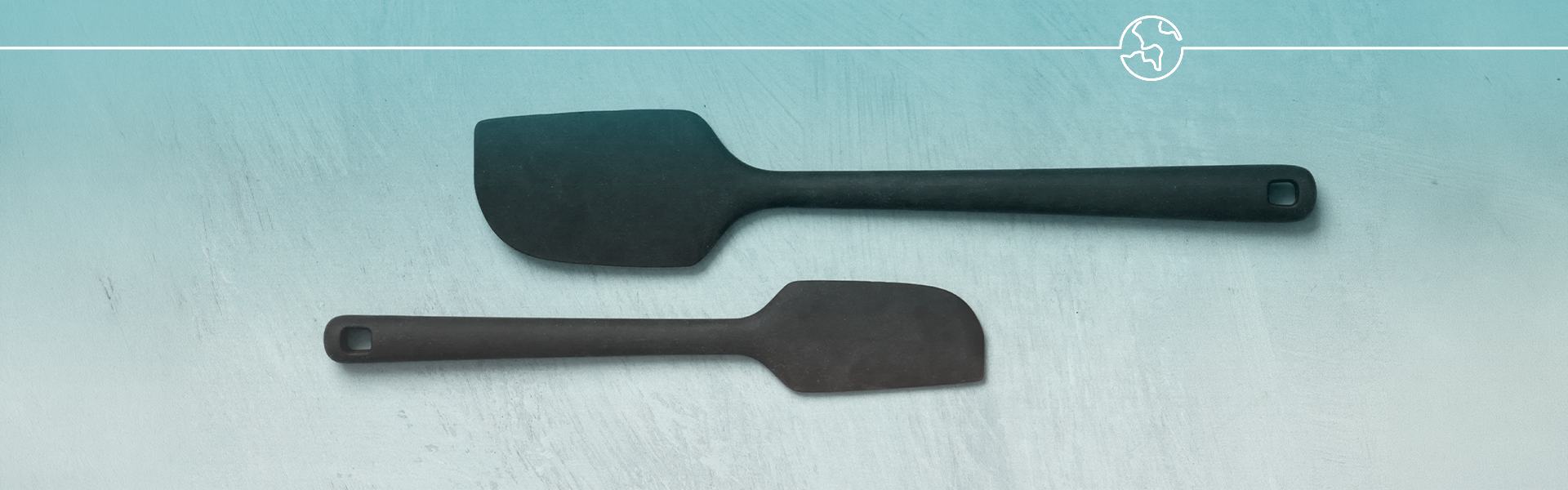 Black silicone spatulas on a pale blue surface with a white line and globe icon overlay.