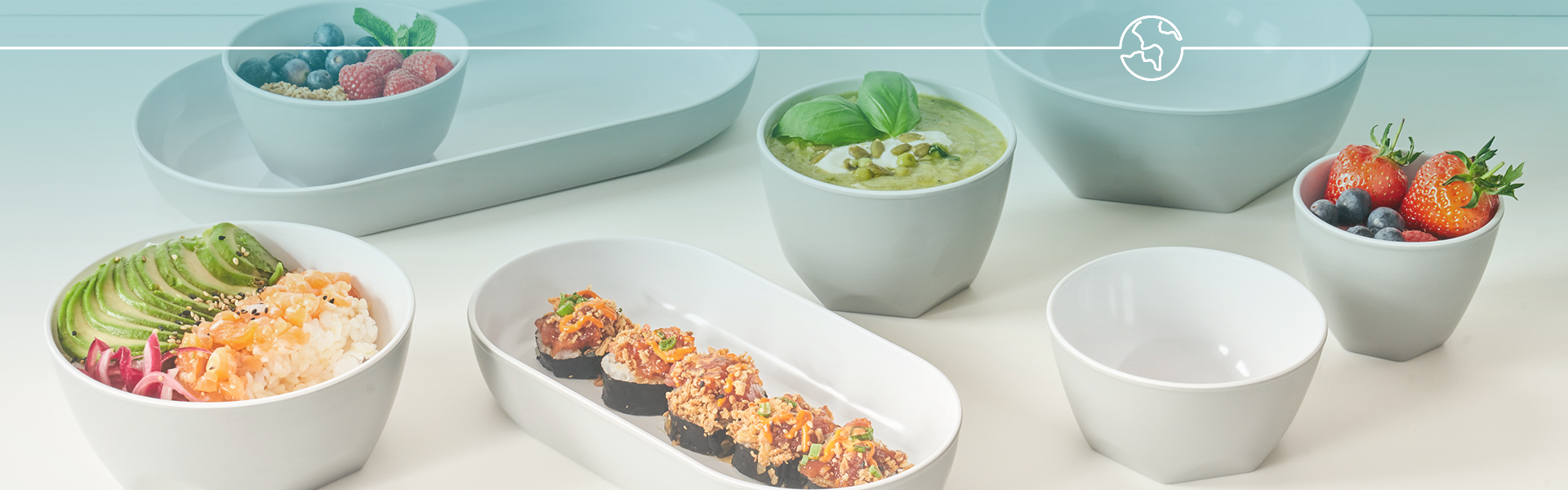 Assorted food items including sushi, salad, and fruit on a light surface with a teal background.