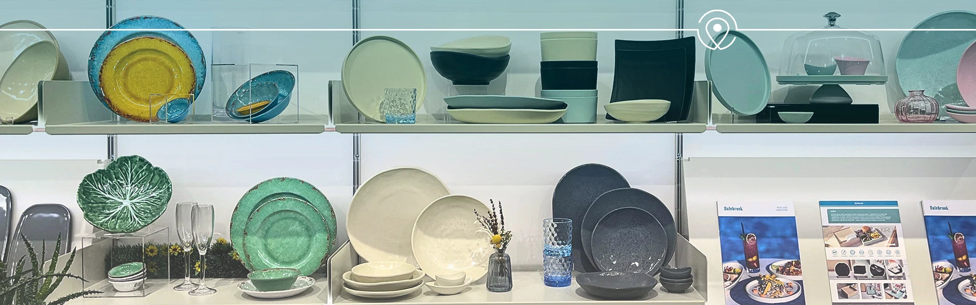 Display of ceramic plates and bowls on shelves with a magazine in the background at Dalebrooks london showroom